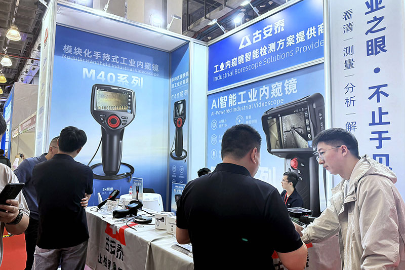 A customer is watching a demonstration of an industrial endoscope at our booth A customer is watching a demonstration of an industrial endoscope at our booth